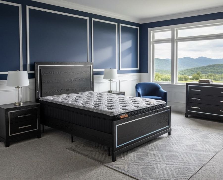 Kingdom Black Cooling Pillow Top mattress with a gray quilted top on a black bed in a furnished bedroom