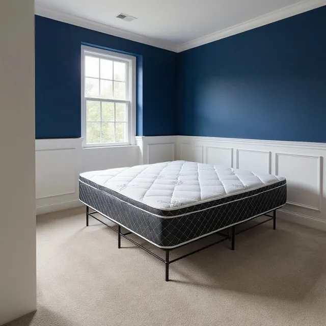 White pillow-top mattress with dark diamond-quilted sides on a black metal bed frame in a blue-walled room